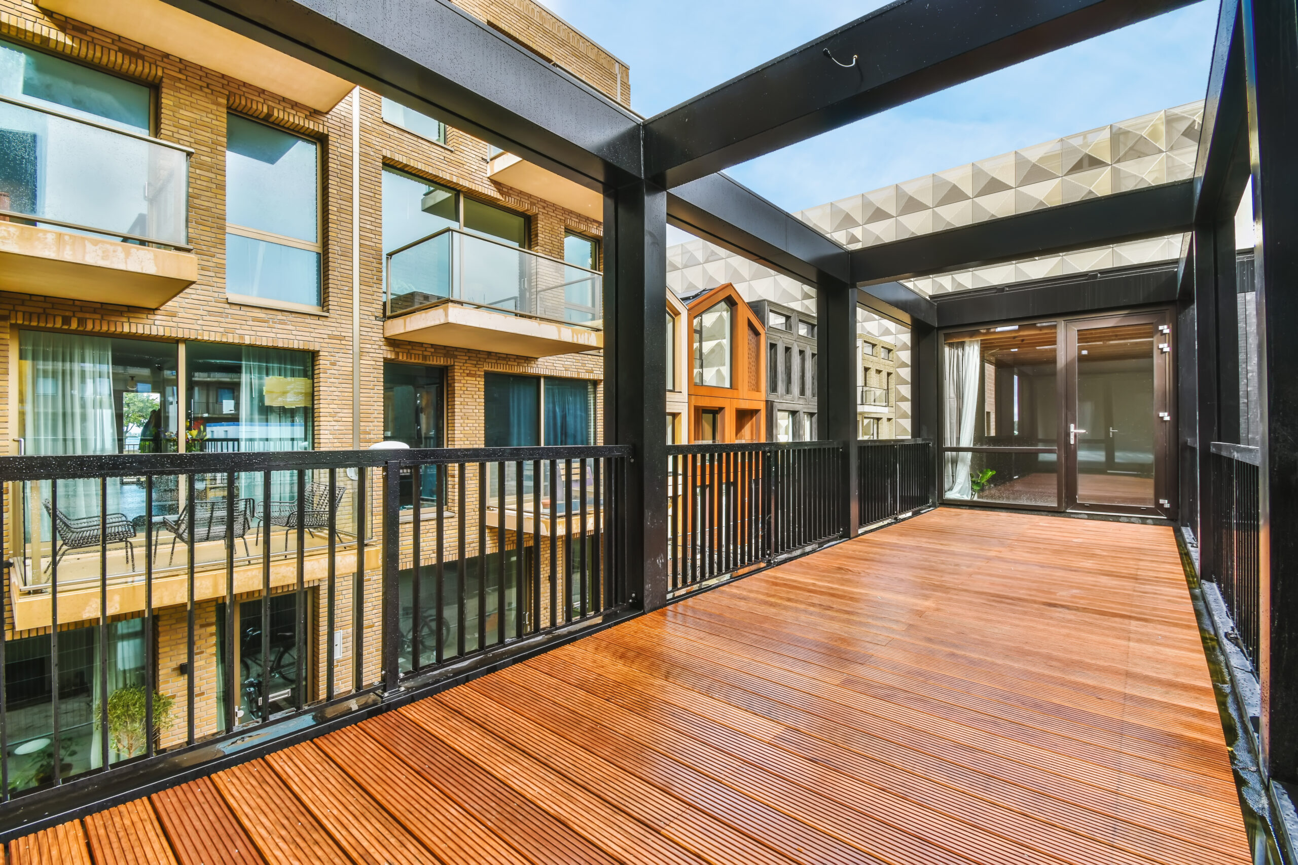 Handsome long narrow balcony with black metal railings